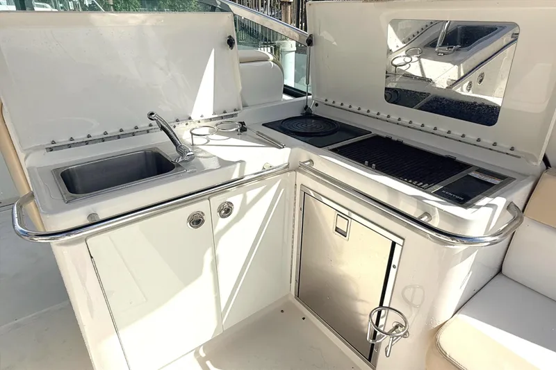 Slide: The Image of 2013 Sea Ray 370 Venture boat kitchenette with sink, grill, and storage. - 8