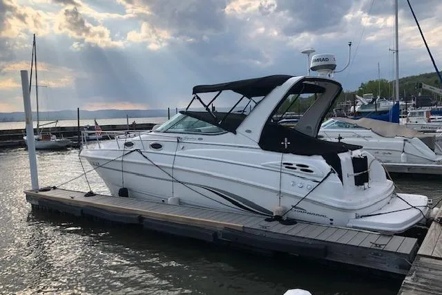 The Image of Chaparral Signature 300 boat, 2000 model, docked at marina under cloudy sky. - 0