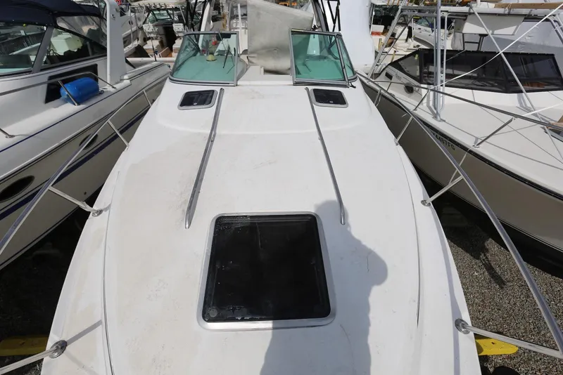 Slide: The Image of 2000 Chaparral Signature 300 boat deck with hatch, docked among other boats. - 10