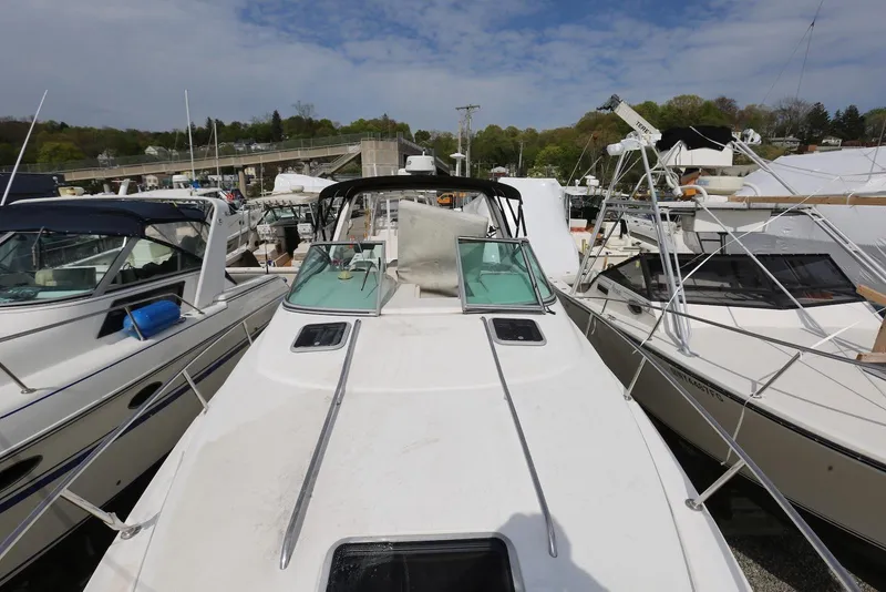 Slide: The Image of 2000 Chaparral Signature 300 boat docked among other vessels under a clear sky. - 11