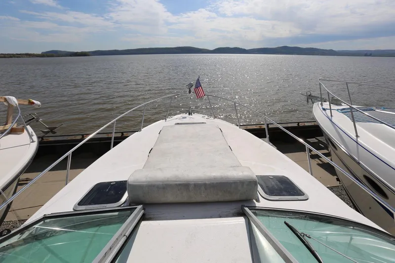 Slide: The Image of 2000 Chaparral Signature 300 boat docked by a scenic lake view. - 12