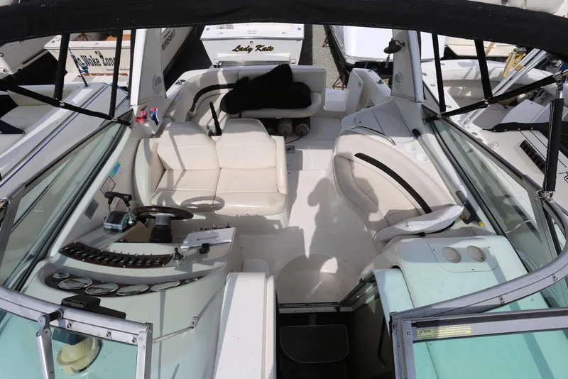 Slide: The Image of 2000 Chaparral Signature 300 boat interior with white seating and control panel. - 13