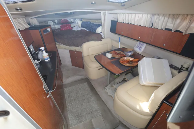 Slide: The Image of Interior of a 2000 Chaparral Signature 300 boat with dining area and bed. - 14