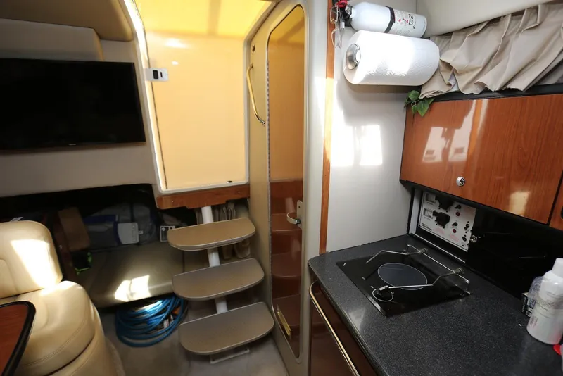 Slide: The Image of Interior of 2000 Chaparral Signature 300 boat with kitchenette and stairs. - 18