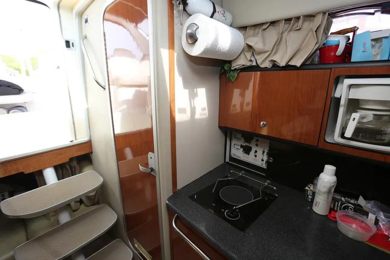Slide: The Image of Interior of 2000 Chaparral Signature 300 boat with kitchenette and wooden cabinetry. - 19