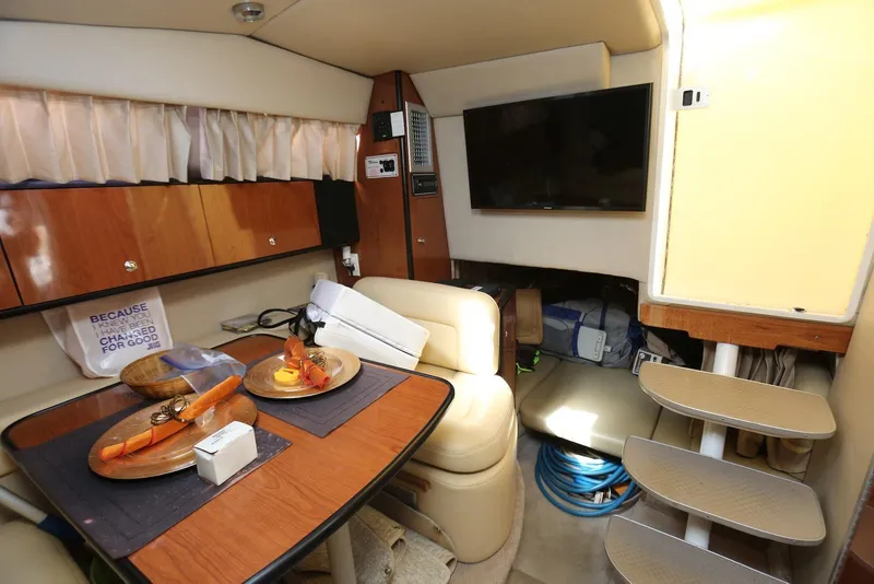 Slide: The Image of Interior of 2000 Chaparral Signature 300 yacht with dining area and TV. - 20