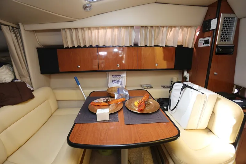 Slide: The Image of Interior of 2000 Chaparral Signature 300 yacht with dining area and wooden cabinetry. - 21