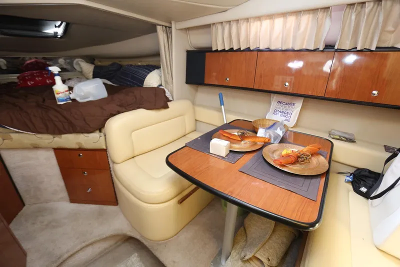 Slide: The Image of Interior of 2000 Chaparral Signature 300 boat with dining area and cozy sleeping space. - 22
