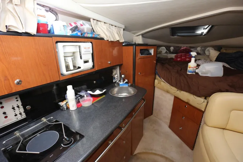 Slide: The Image of Interior of 2000 Chaparral Signature 300 boat with kitchenette and cozy sleeping area. - 26