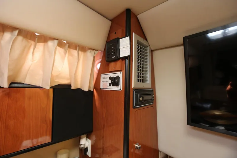 Slide: The Image of Interior of 2000 Chaparral Signature 300 boat with wood paneling and electronic controls. - 29