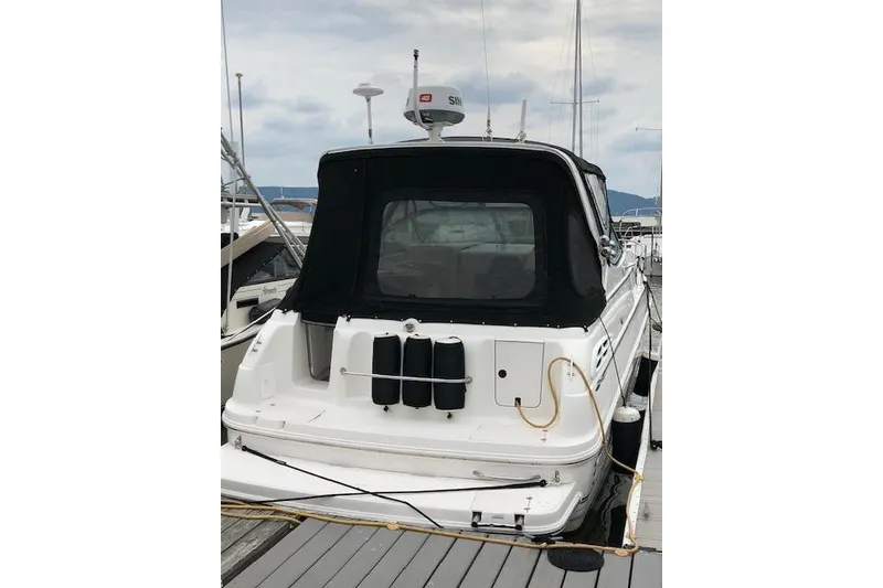 Slide: The Image of 2000 Chaparral Signature 300 boat docked at marina, rear view with black canopy. - 3