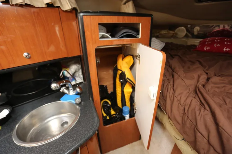 Slide: The Image of Interior of 2000 Chaparral Signature 300 with sink, storage, and bed. - 30
