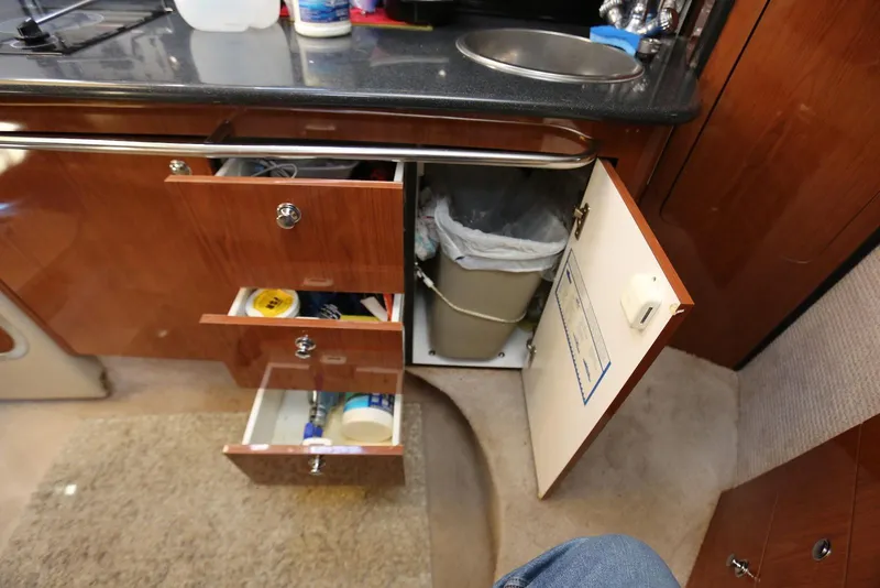 Slide: The Image of Interior of 2000 Chaparral Signature 300 with open drawers and cabinet in kitchenette. - 33