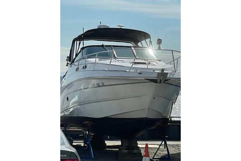 Slide: The Image of 2000 Chaparral Signature 300 boat on dry dock, front view, sunny day. - 4