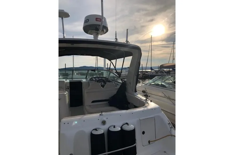 Slide: The Image of Chaparral Signature 300 boat, 2000 model, docked at sunset with visible cockpit and radar. - 5