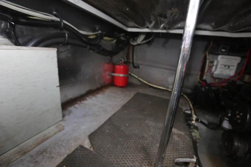 Slide: The Image of Engine compartment of a 2000 Chaparral Signature 300 boat, featuring wiring and a fire extinguisher. - 52