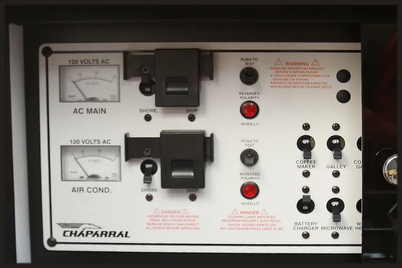 Slide: The Image of Engine compartment of a 2000 Chaparral Signature 300 boat, showcasing wiring and components. - 58