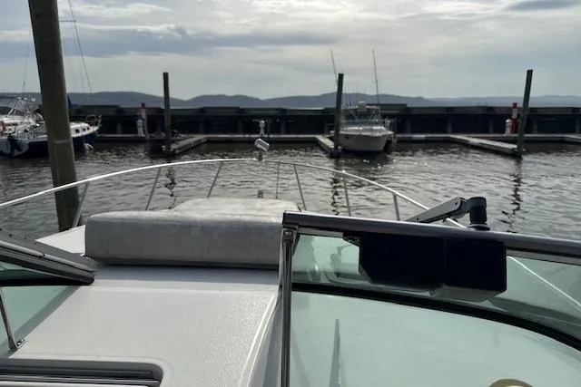 Slide: The Image of 2000 Chaparral Signature 300 boat docked at a marina with scenic water view. - 6