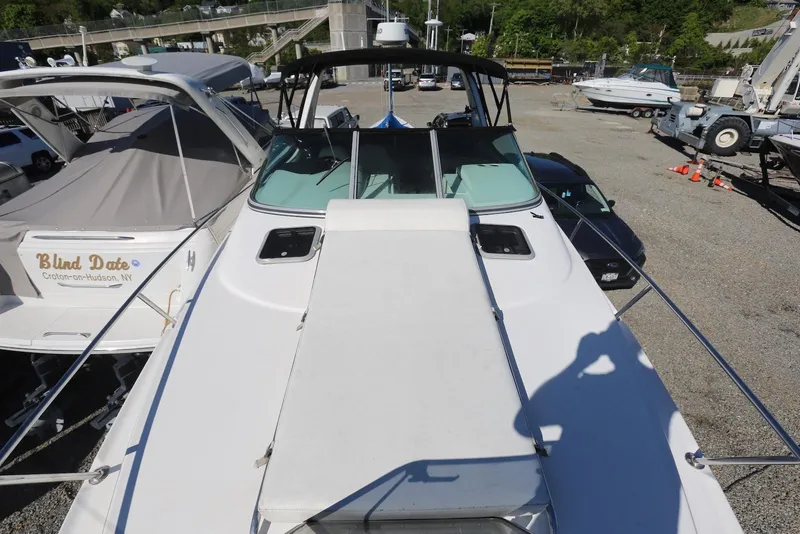 Slide: The Image of 2000 Chaparral Signature 300 boat docked, featuring spacious deck and sleek design. - 64