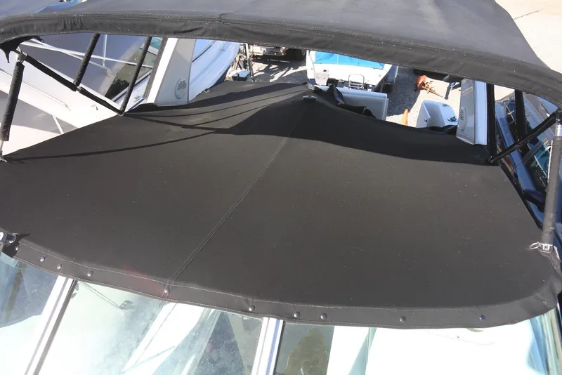 Slide: The Image of 2000 Chaparral Signature 300 boat with black canvas cover and bimini top. - 66
