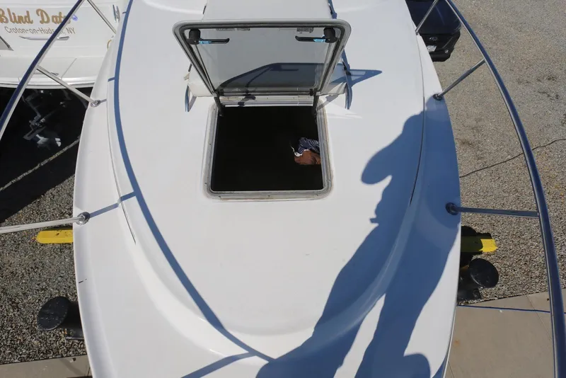 Slide: The Image of 2000 Chaparral Signature 300 boat deck with open hatch, shadow visible. - 68