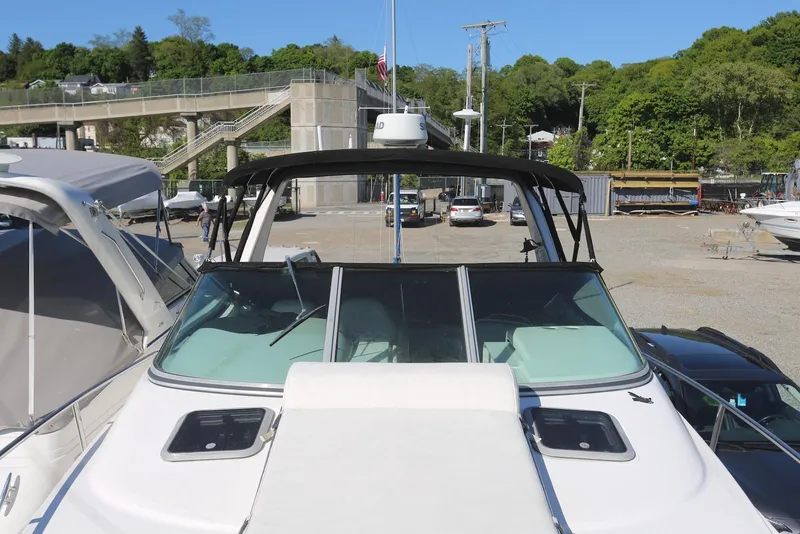 Slide: The Image of Chaparral Signature 300 boat, 2000 model, docked with scenic background and clear blue sky. - 69