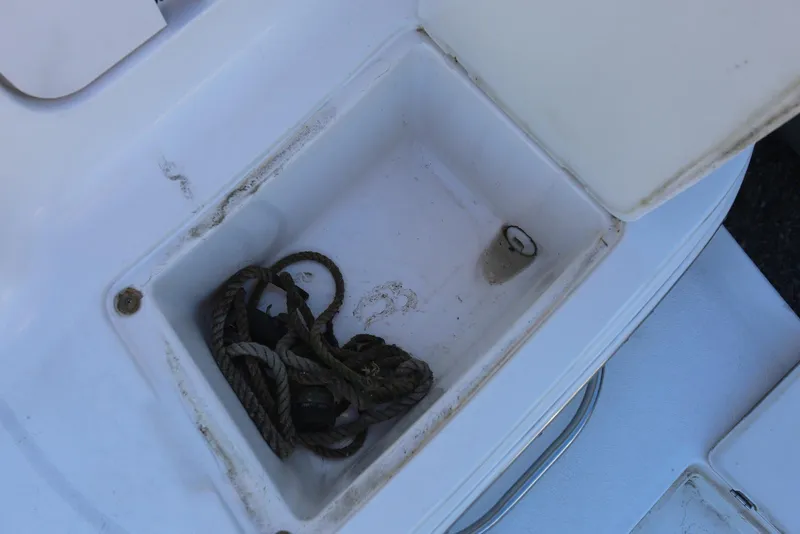 Slide: The Image of Storage compartment with rope on a 2000 Chaparral Signature 300 boat. - 77