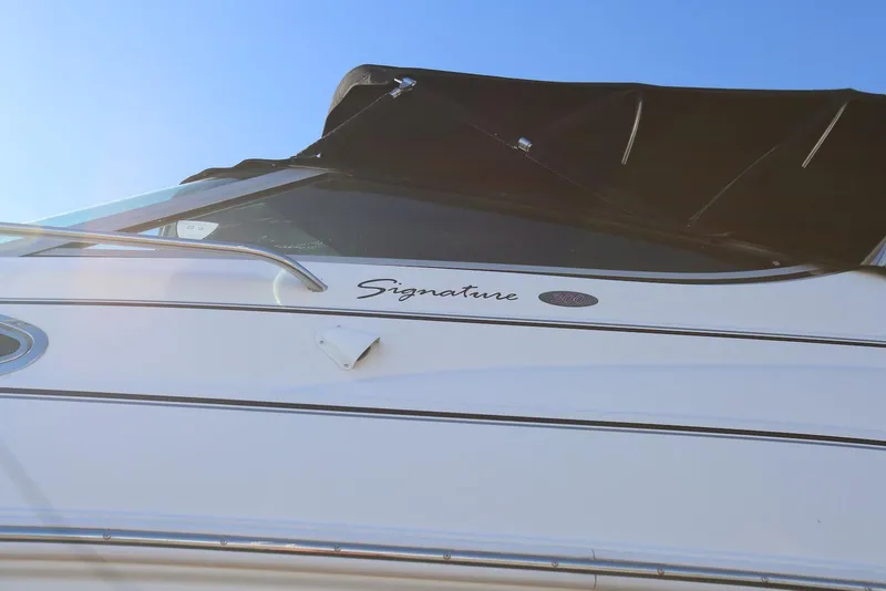 Slide: The Image of Chaparral Signature 300 boat, 2000 model, with sleek design under clear blue sky. - 83