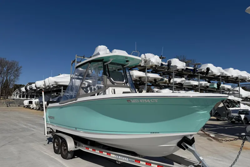 Slide: The Image of 2020 Blackfin 242 CC boat on trailer, parked in marina storage area. - 17