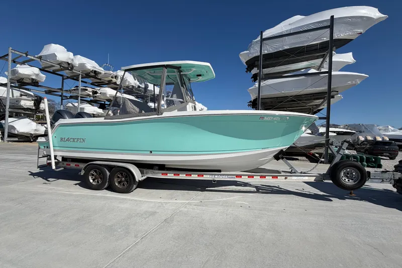 Slide: The Image of 2020 Blackfin 242 CC boat on trailer in storage facility. - 20