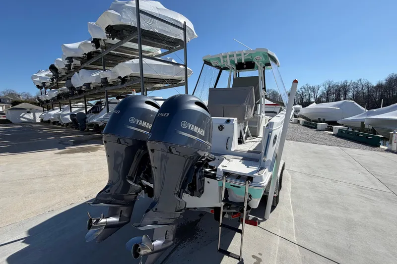 Slide: The Image of 2020 Blackfin 242 CC boat with twin Yamaha engines in a marina storage area. - 25