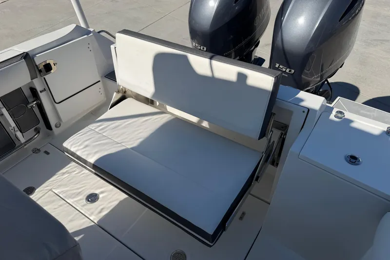 Slide: The Image of 2020 Blackfin 242 CC boat interior with foldable seat and dual Yamaha 150 engines. - 31