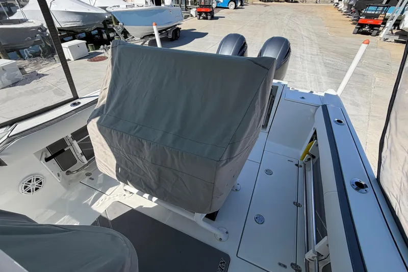 Slide: The Image of 2020 Blackfin 242 CC boat interior with covered seating and dual engines. - 33