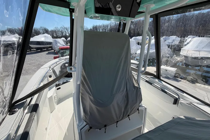 Slide: The Image of 2020 Blackfin 242 CC boat interior with covered seating and clear enclosure. - 34