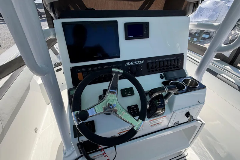 Slide: The Image of 2020 Blackfin 242 CC boat helm with steering wheel and control panel. - 35
