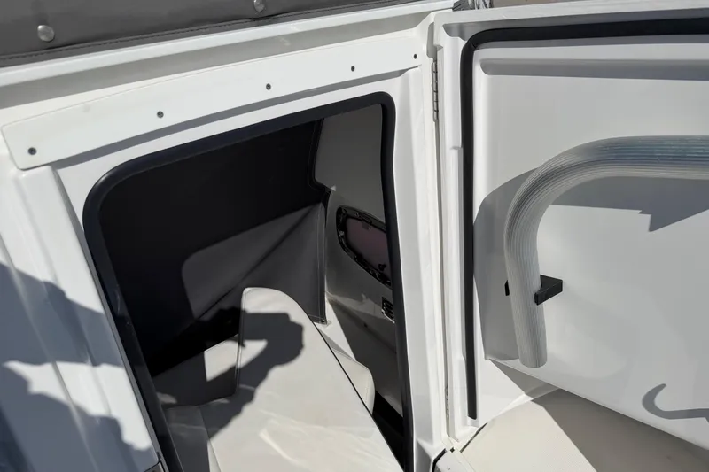 Slide: The Image of 2020 Blackfin 242 CC boat interior cabin with open door and seating area. - 40