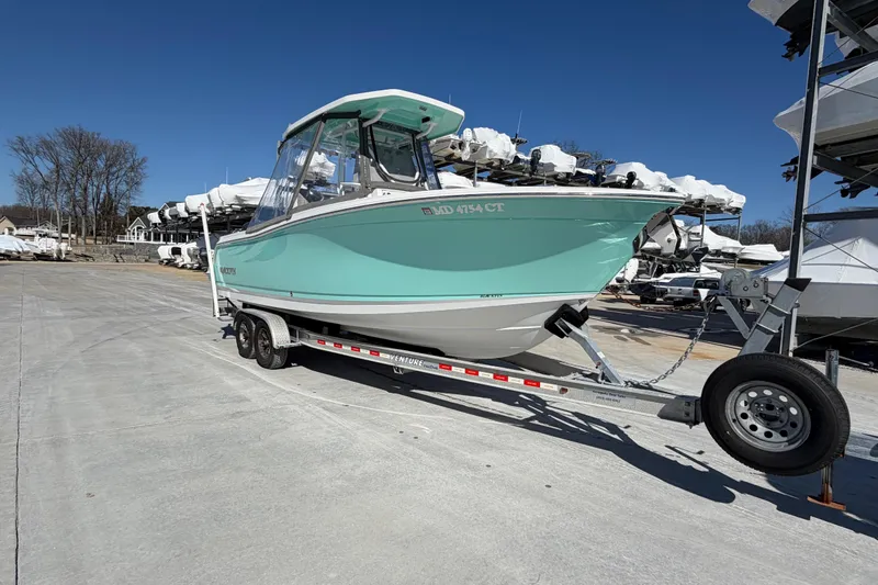 Slide: The Image of 2020 Blackfin 242 CC boat on trailer in marina under clear blue sky. - 5