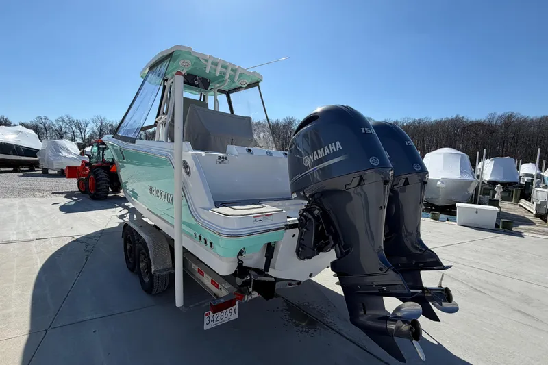 Slide: The Image of 2020 Blackfin 242 CC boat with twin Yamaha engines on a trailer. - 9