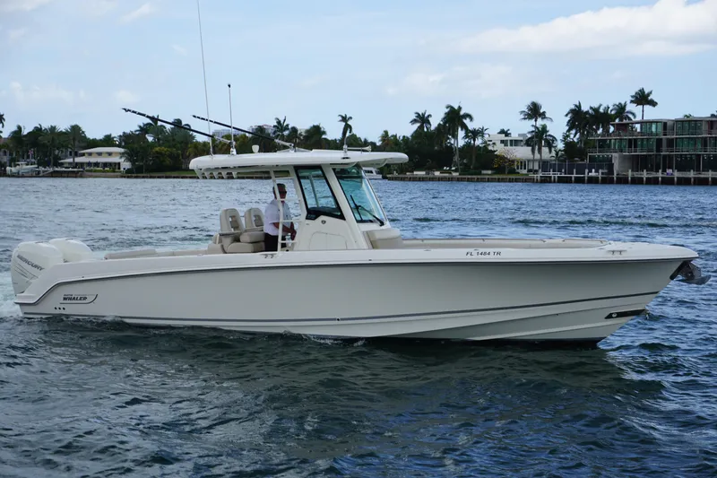The Image of 2018 Boston Whaler 330 Outrage boat cruising on a scenic waterway. - 0