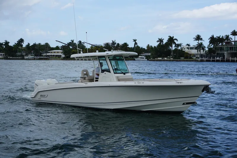 Slide: The Image of 2018 Boston Whaler 330 Outrage boat cruising on a scenic waterway. - 4