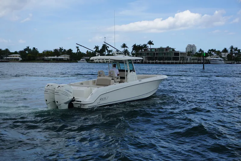 Slide: The Image of 2018 Boston Whaler 330 Outrage boat cruising on a scenic waterway. - 6