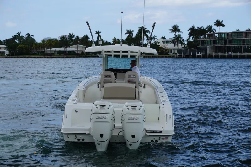 Slide: The Image of 2018 Boston Whaler 330 Outrage boat cruising on a scenic waterway. - 8