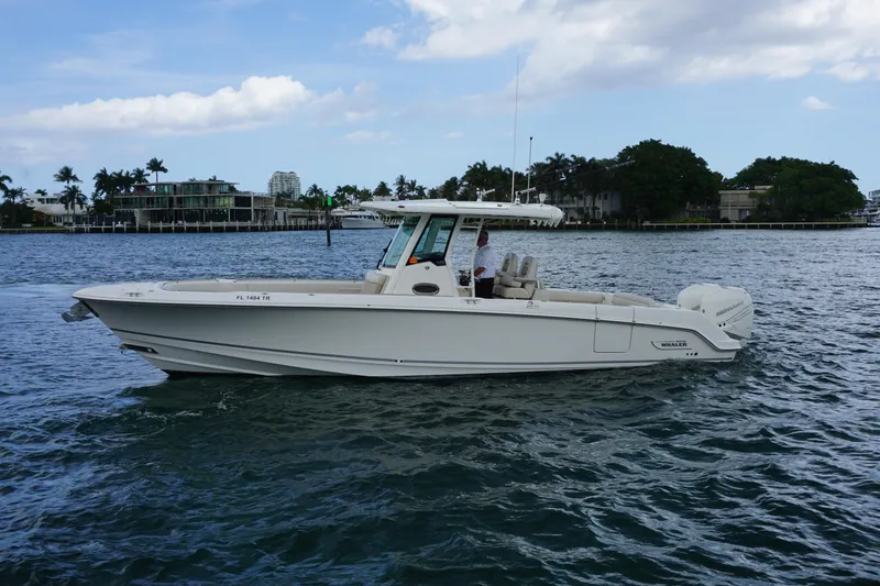 Slide: The Image of 2018 Boston Whaler 330 Outrage boat cruising on a scenic waterway. - 9