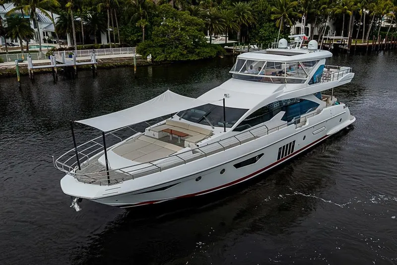 Slide: The Image of Luxury 2017 Azimut 80 yacht cruising on a serene waterway, surrounded by lush greenery. - 103