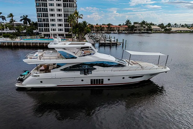 Slide: The Image of Luxurious 2017 Azimut 80 yacht docked near waterfront residences, showcasing sleek design and elegance. - 105