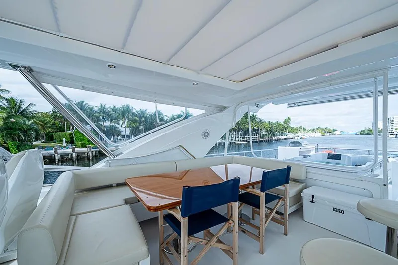 Slide: The Image of Luxurious 2017 Azimut 80 yacht deck with seating, table, and waterfront view. - 22