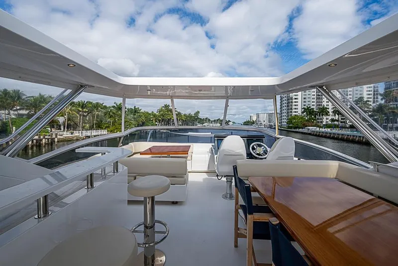 Slide: The Image of Luxurious 2017 Azimut 80 yacht deck with seating, table, and scenic waterfront view. - 28