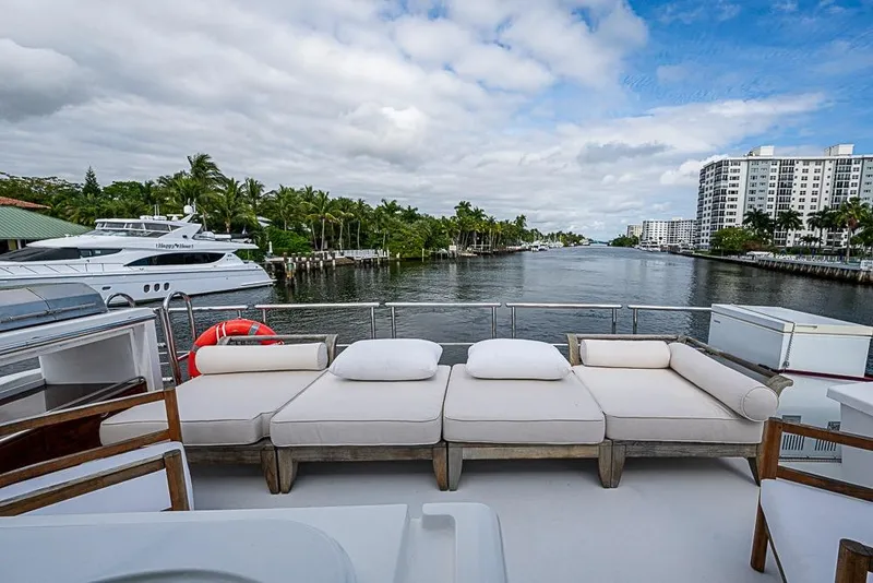 Slide: The Image of Luxurious 2017 Azimut 80 yacht deck with plush seating, overlooking a scenic waterway. - 33
