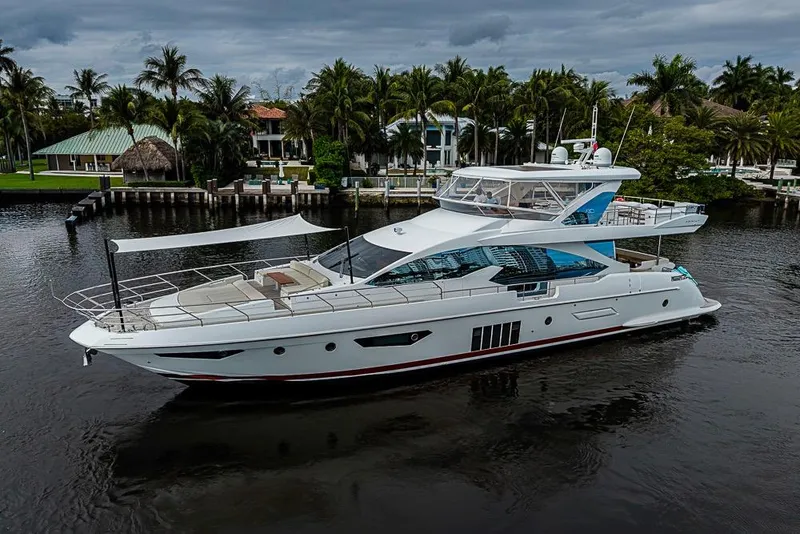 Slide: The Image of 2017 Azimut 80 yacht cruising on a scenic waterway with palm trees. - 4