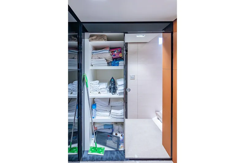 Slide: The Image of Storage area with shelves and cleaning supplies on a 2017 Azimut 80 yacht. - 88